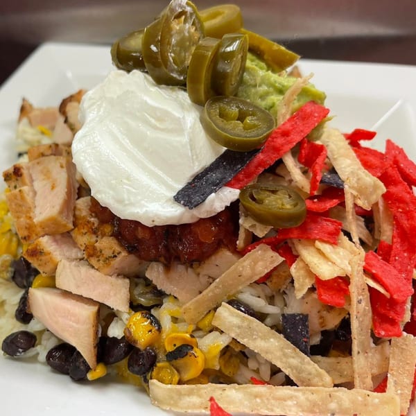 Stadium 34's chicken bowl with rice, beans, corn, salsa, sour cream, guacamole, jalapeños, and tortilla strips.